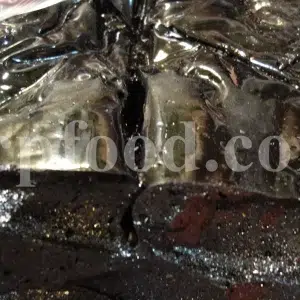 Bulk licorice extract in solid black blocks wrapped in transparent plastic