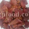 Bulk pomegranate peel for export shown as dried red rind pieces on a glass plate