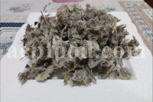 Dried Persian mountain tea flowering material piled on a square white plate